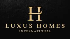 LUXUS HOMES INTERNATIONAL logo